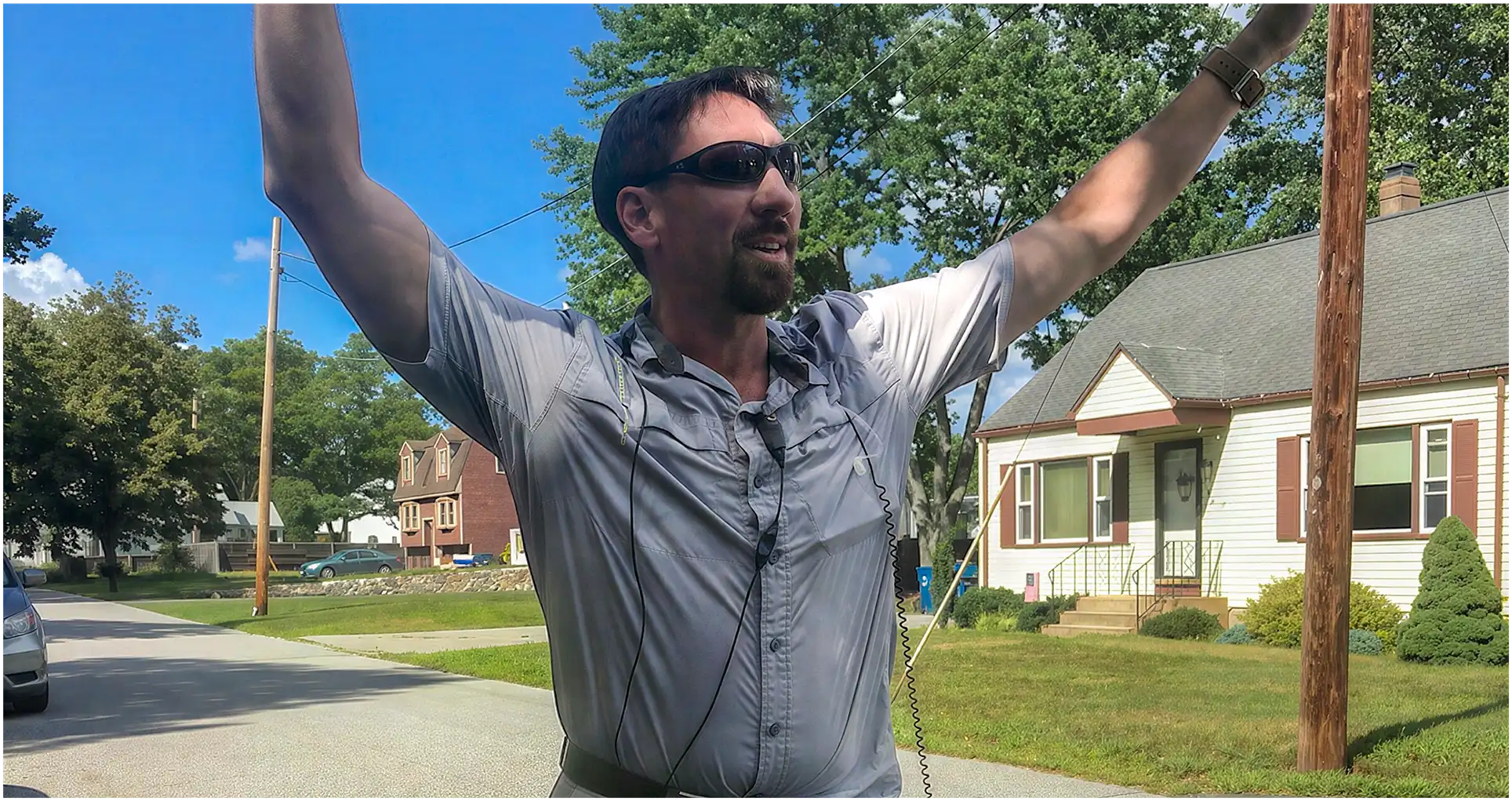 Matt Wilkins standing and directing for a TV show on a street in a suburban neighborhood